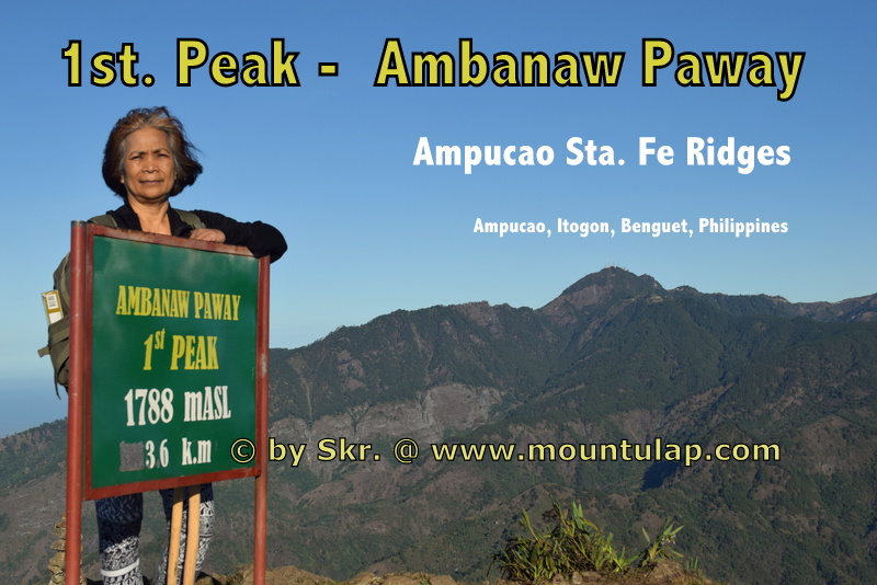  One Senior Citizen standing beside the 1st. Peak marker thereby at the far distance Mount Santo Tomas is visible. 